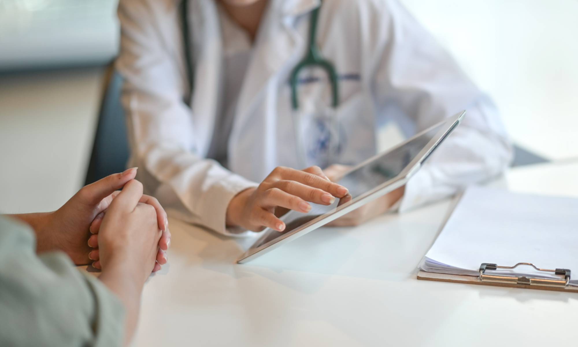 Doctor and patient reviewing electronic health record Doctor and patient reviewing electronic health record
