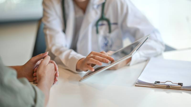 Doctor and patient reviewing electronic health record Doctor and patient reviewing electronic health record