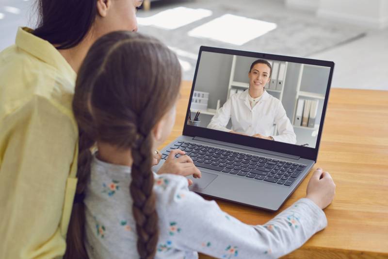 Mother and kid consulting a doctor online Mother and kid consulting a doctor online